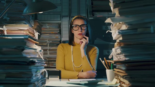 Pensive office worker thinking with hand on chin