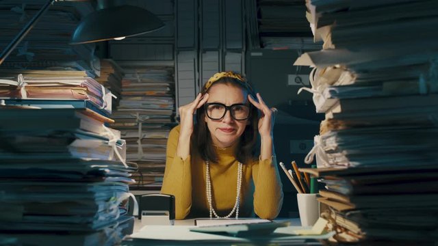 Exhausted office clerk with headache