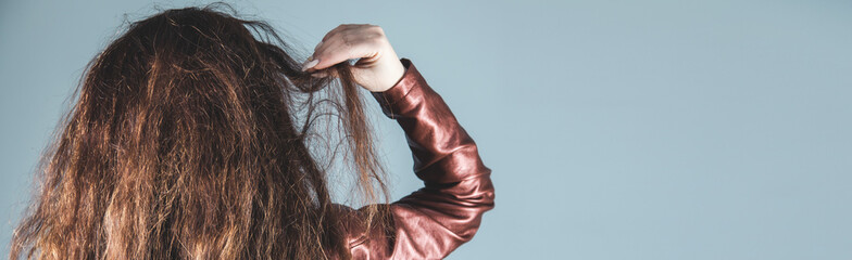 woman brown long hair on the gray wall background