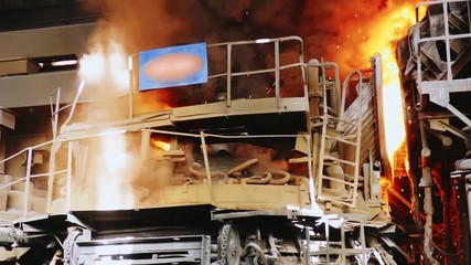 Steel production in a steelmaking furnace. Metallurgy. Casting ingot. Electric arc furnace shop. Shop EAF. Plant for the production of steel. An electric melting furnace. Close up.