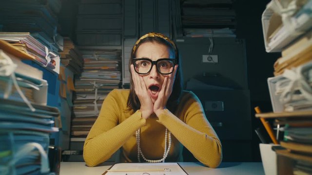 Shocked office worker receiving an unexpected bad surprise
