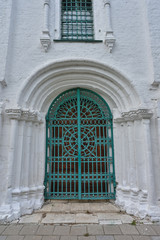 Fototapeta na wymiar green metal door in white building