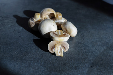 champignon mushrooms on gray table background