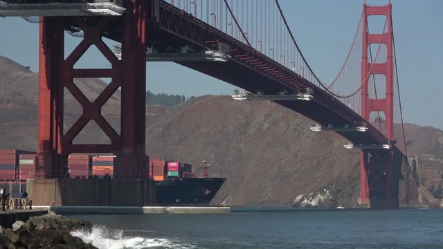 Container ship at sea sailing under the Golden Gate Bridge