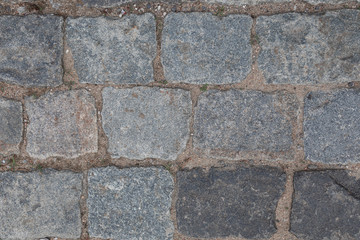 Grey masonry on street, background with grunge texture