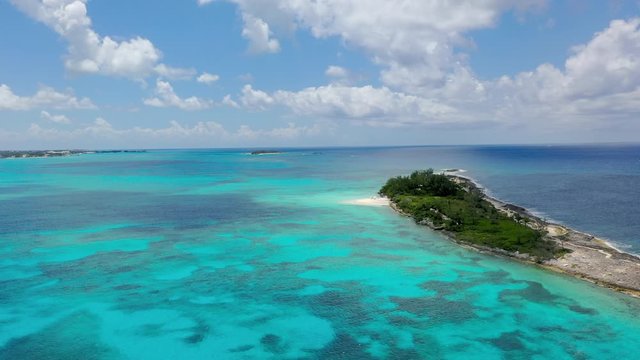 Aerial: Narrow Peninsula in Gorgeous Aquamarine Tropical Water on a Sunny Day - Nassau, Bahamas
