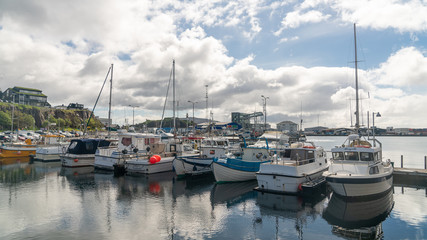 Fototapeta premium Fishing boats in Torshavn harbour on Faroe islands.
