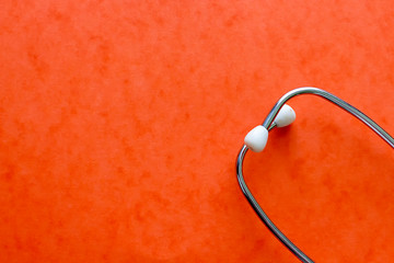     Stethoscope on orange background 