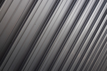 Diagonal view of shiny grey corrugated surface