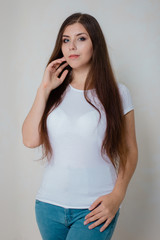 portrait of a young girl in a white t-shirt on a white background