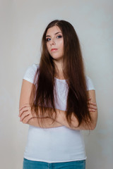 portrait of a young girl in a white t-shirt on a white background