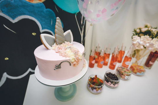 very beautiful colorful eye-catching candy Bar with cocktails and sweet unicorn cake pie. Pink color cake and chocolate. kendi bar on children's birthday. photo example for cake shop