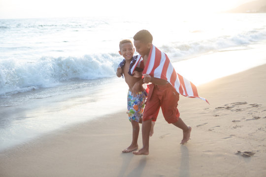 Patriotic fun at the beach boys running with the American flag