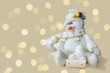 Cute decorative snowman on isolated bright bokeh light background with copy space. Composition of festive mood. Christmas and new year greeting card