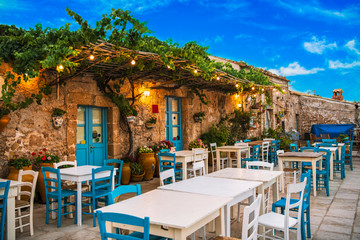 Famous colorful outdoor cafe in the most beautiful sicilian village Marzamemi in Sicily, south Italy - obrazy, fototapety, plakaty