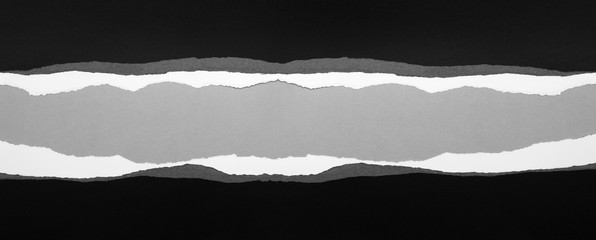 Ripped black paper on grey wide banner background