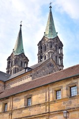 Fototapeta na wymiar Bamberg, Germany - May 2019. Historical building in th old town of Bamberg (Bavaria, Franconia). View on famous tourist attraction in the center of Bamberg. Tourists visiting the sights of the town 