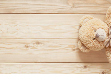 teddy on wooden background