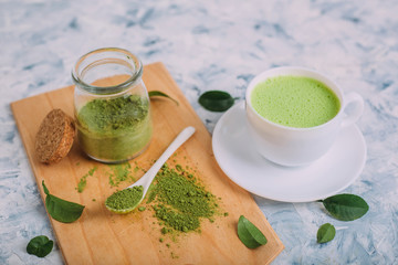  White cups with matcha and powder for its preparation.