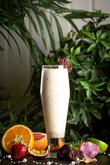 milkshake with a date in a glass and fruits