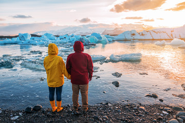 red-yellow couple looking at blue icebergs