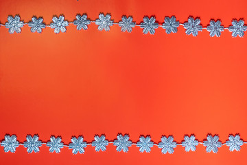 Christmas bright red background with silver snowflakes around the perimeter. Christmas concept. Place for text. Copy space