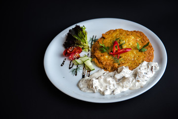 Dish in a white plate on a black background