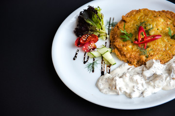 Dish in a white plate on a black background