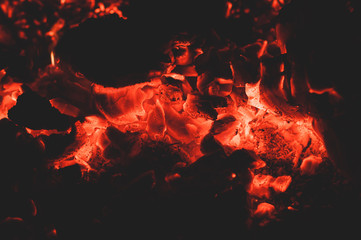 Bright colorful glowing orange-red embers bonfire.