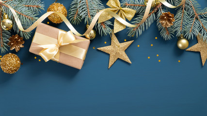 Wide Christmas border with fir branches, golden stars and baubles, gift box, ribbon bow, confetti...