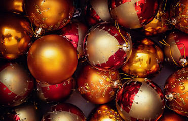 Festive Christmas balls in the box. A lot of red and yellow balls. Christmas background, texture