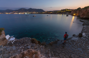 the guy on the edge of the cliff looks into the distance