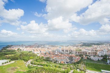 Fototapeta na wymiar Panoramic view of the Tagus river and the buildings of Almada , this picture was captured from the National Sanctuary of Christ the King statue in Lisbon , Portugal . 