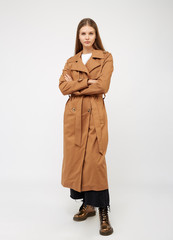 Female trench coat camel color isolated on white background.