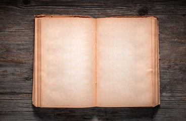 Vintage book, open, on old wooden table, with clipping path. Open Book blank on old wooden background. book with blank pages