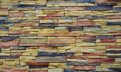 wall of multi-colored stone blocks of different sizes