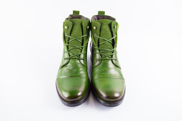 Pair of male green leather boots on white background, isolated product, top view.