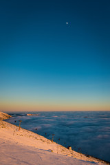 Sunset above the clouds. Winter inversion in Chopok - Low Tatras National Park, Slovakia
