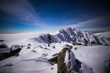 Starry winter night on the mountains. Inversion and clouds in a valley. Low Tatras National Park, Slovakia