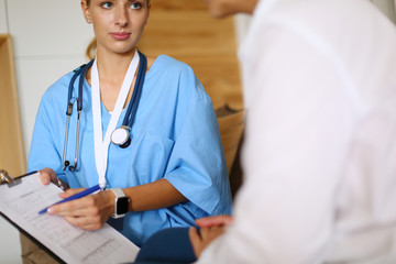 Woman doctor explaining diagnosis to her female patient