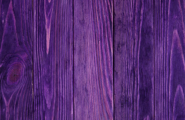 Purple violet saturated painted wooden background with parallel vertical planks 