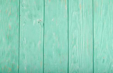 Obraz premium Light turquoise painted wooden background with parallel vertical planks 