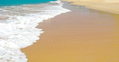 Sea beach with white sea foam and yellow sand. Vacation on sandy beach. Abstract summer resort and...
