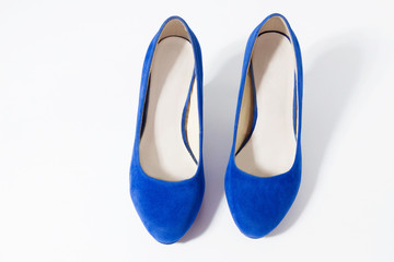 Closeup of women blue shoes top view isolated on white background. Copy space. Fashion and shopping concept. Woman stylish footwear. Selective focus.