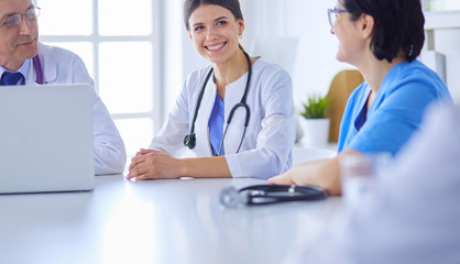 Serious medical team discussing patient's case in a bright office