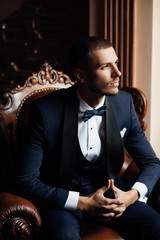 The groom put on straightens cufflinks. The groom fasten cufflinks on the cuffs of the shirt. The...