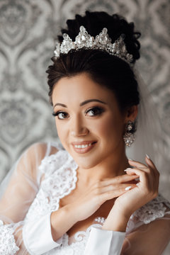 Beautiful bride portrait wedding makeup and hairstyle, girl in diamonds tiara and marriage dress, fashion bride gorgeous beauty, smiling happy bride portrait. 