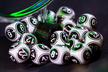 Black and white lottery balls in a machine