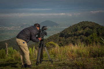 Man filming a landscape for a nature documentary to mexican landscape, Jiquipilco, Mexico 