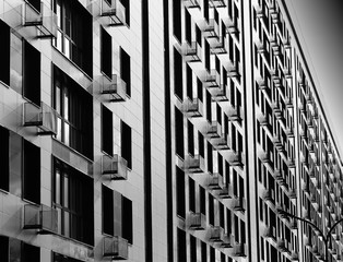 Fototapeta premium Minimalistic black and white building with multiple balconies